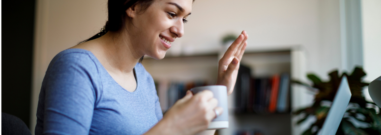 Young woman aving at her screen